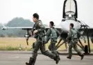 Taiwan Air Force pilots run past a F-16V fighter jet during a military training exercise in Chiayi County, Taiwan, on Wednesday, Jan. 5, 2022. Taiwan is bracing for more Chinese military patrols this year, after Peoples Liberation Army incursions more than doubled in 2021, fueling concern about a clash between the regions big powers. Photographer: I-Hwa Cheng/Bloomberg